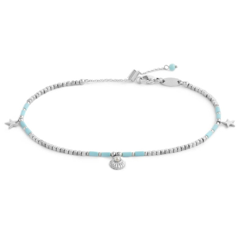 Cavigliera con ematite cubica alternata a perline conchiglia e stelle marine pendenti Marlú
